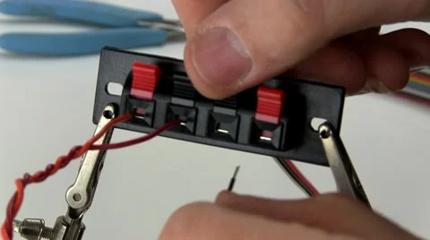 Attaching wire to speaker terminals strip Stock Footage 10588974