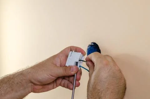 Attaching wires to a light switch Stock Photos