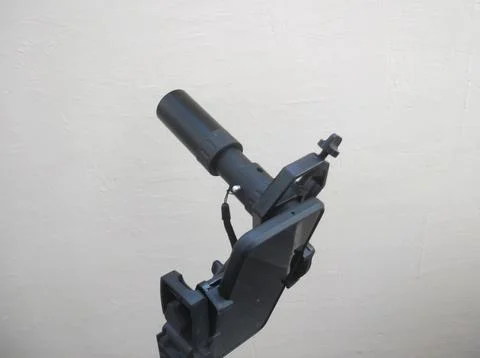 Attachment between monocular telescope and smartphone on a tripod Stock Photos