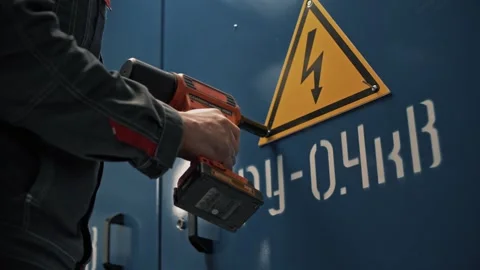 Attachment of a yellow triangle with a lightning bolt to warn of the dangers Stock Footage 265509350