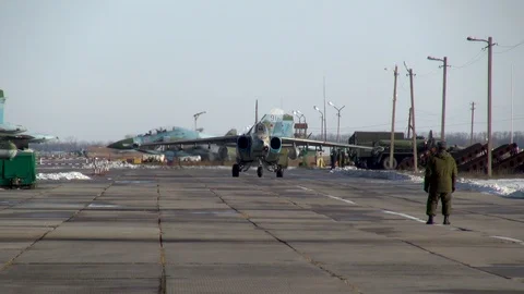 Attack aircraft Su-25SM (Frogfoot) is taxiing to parking lot after landing. Stock Footage 122734475