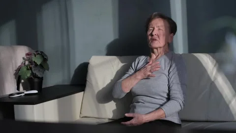 Attack and exacerbation of the disease in an old woman sitting on the sofa Stock-Footage 260415567