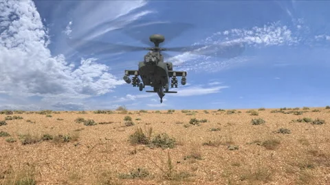 Attack helicopter fires machine gun and rockets at camera in the desert Stock Footage 260283254