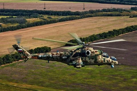 Attack helicopter Mi-35P in flight, view from a parallel helicopter (export v Stock Photos