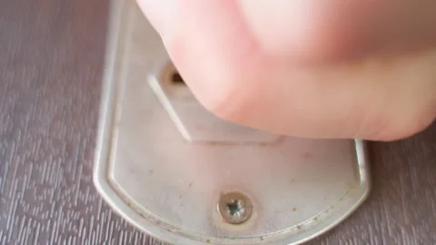 The attacker inserts the key into the lock and turns it, close-up Stock Footage 279075273
