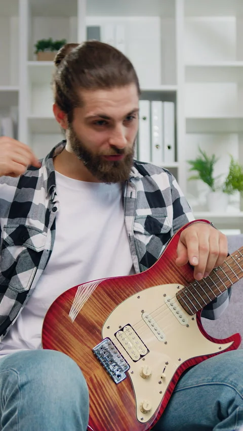 Attaractive man recording music with his laptop in the living room of his house. Stock Footage 327617153