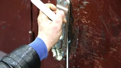 Attempt to break the lock in the door Stock Footage 115048230