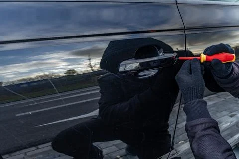 Attempted car theft using a suitcase in the city center Stock Photos