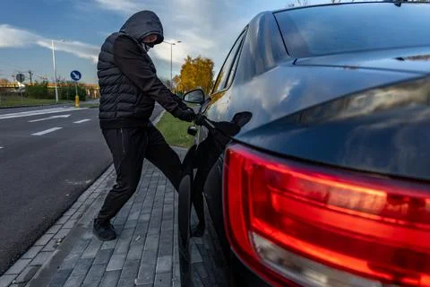 Attempted car theft using a suitcase in the city center Stock Photos