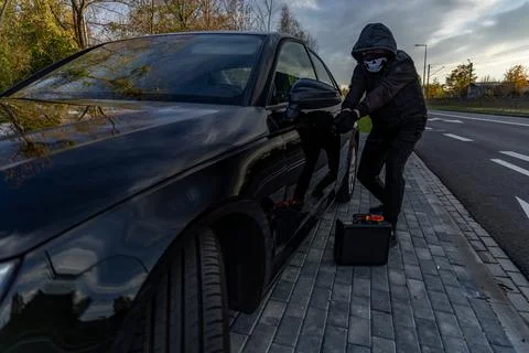Attempted car theft using a suitcase in the city center Stock Photos