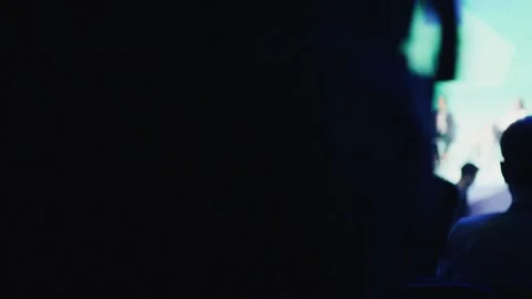 Attendee following crypto conference presentation Stock Footage 306582202