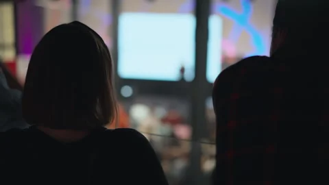 Attendee gazes towards a stage at a tech event, signifying focus on innovative Video stock 269003397