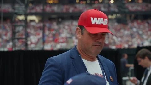 An attendee in a red cap at the Charlie Kirk memorial service Stock Footage 345297874
