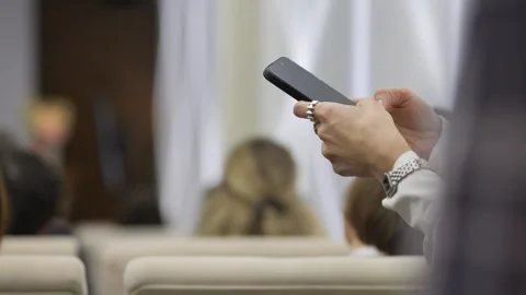 Attendee uses device while seated in seminar setting Stock Footage 342000927