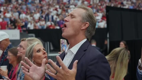 Attendees greet each other before the memorial service at State Farm Stadium Stock Footage 345297831