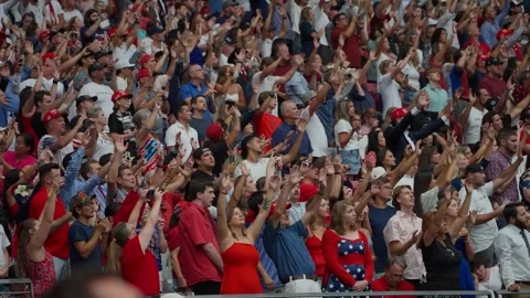 Attendees raise their arms during the Charlie Kirk memorial service Stock-Footage 345298038
