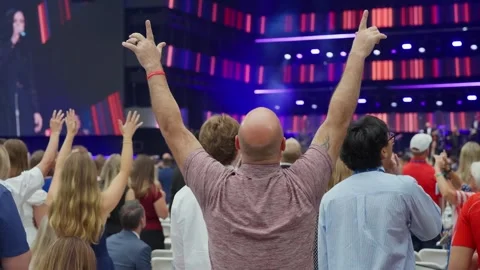 Attendees raise their hands in prayer during the Charlie Kirk memorial service Stock Footage 345297849
