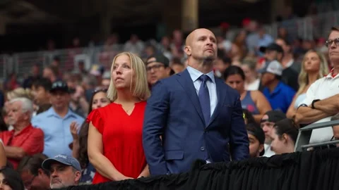 Attendees stand in the stadium before the Charlie Kirk memorial service Stock Footage 345297965