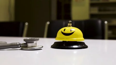 Attender call to patient through smiley bell, Yellow bell ringing by staff Stock Footage 132631333