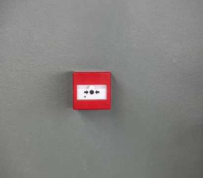 Attention. Close up view of button fire alarm. Greece. Stock Photos
