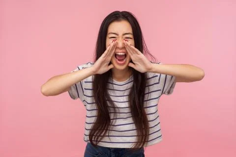 Attention, important message! Portrait of aggressive girl with long hair scre Stock-Fotos