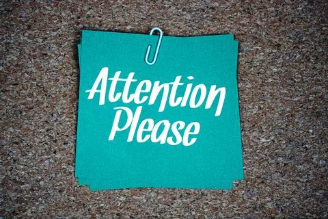 Attention Please text message on stick note on cork paper background Stock Photos