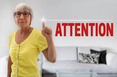 Attention touchscreen is shown by senior Stock Photos