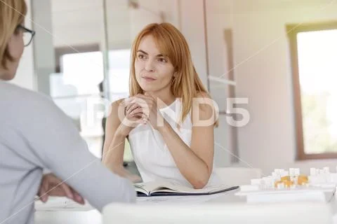 Attentive businesswoman listening to colleague in meeting Stock Photos