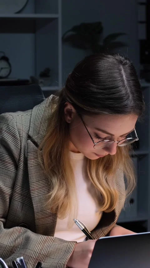 Attentive Office Worker Inspecting Documents And Working In The Evening Office Stock Footage 303861035