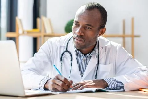 Attentive practitioner looking at computer Stock Photos