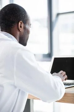 Attentive practitioner looking at his gadget Stock Photos