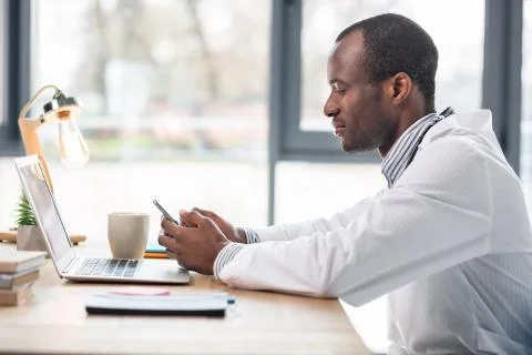 Attentive practitioner sitting in semi position Stock Photos