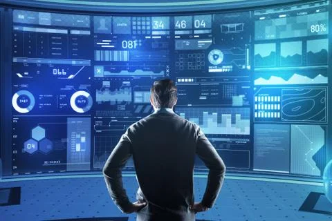 Attentive programmer looking concentrated while standing in front of the screen Stock Photos