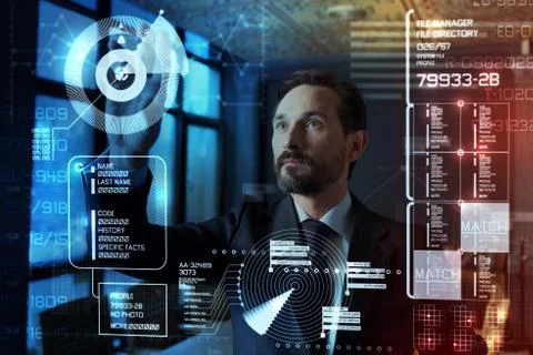 Attentive programmer looking at the information on a transparent screen Stock Photos
