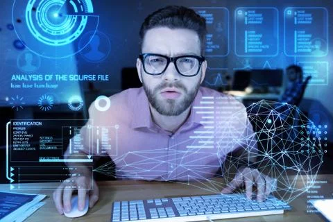 Attentive programmer looking at the transparent screen Stock-Fotos