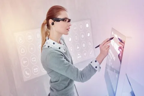 Attentive programmer using a stylus while working on her computer Stock Photos