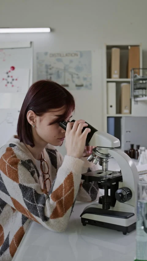 Attentive Student Using Microscope During Biology Class in Lab Stock Footage 312326687