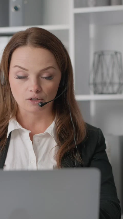 An attentive technical support consultant in the call center provides qualified Stock Footage 274301234