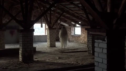 Attic haunted by solitary ghost, soft daylight filters through small windows Stock Footage 320247965