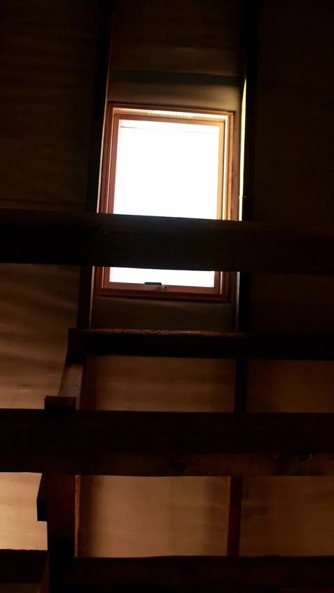 Attic roof interior under construction with a wooden window framing and a l.. Stock Footage 345128316