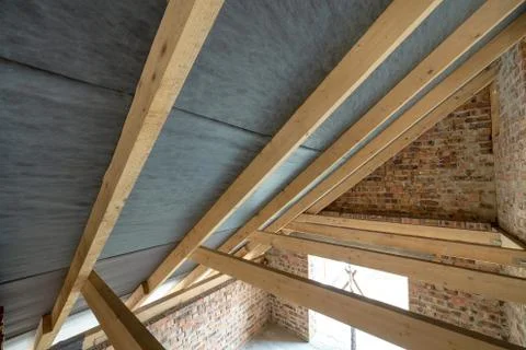 Attic space of a building under construction with wooden beams of a roof stru Stock Photos