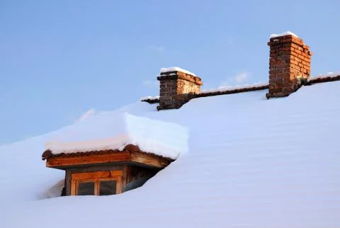 Attic window and two chimneys in winter Stock Photos
