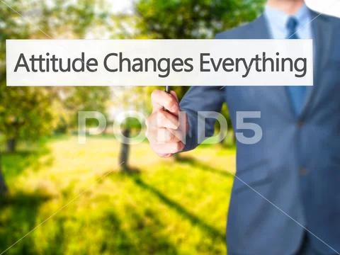 Attitude Changes Everything - Businessman hand holding sign Stock Photos