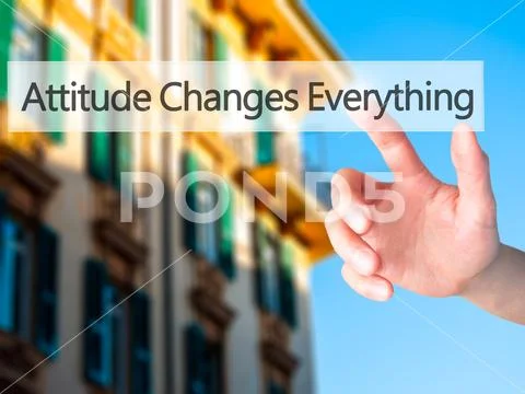 Attitude Changes Everything - Hand pressing a button on blurred Stock Photos