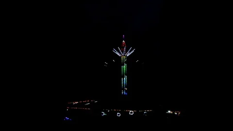Attraction carousel on a long stock, multi-colored with light bulbs in night Stock Footage 112420087