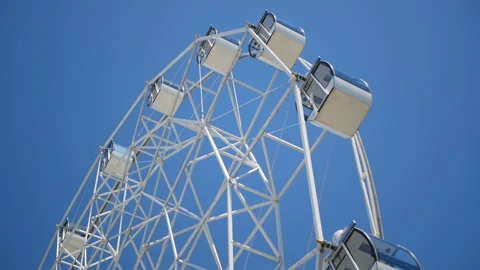 Attraction Ferris wheel on the background of clear sky. Video stock 113817944