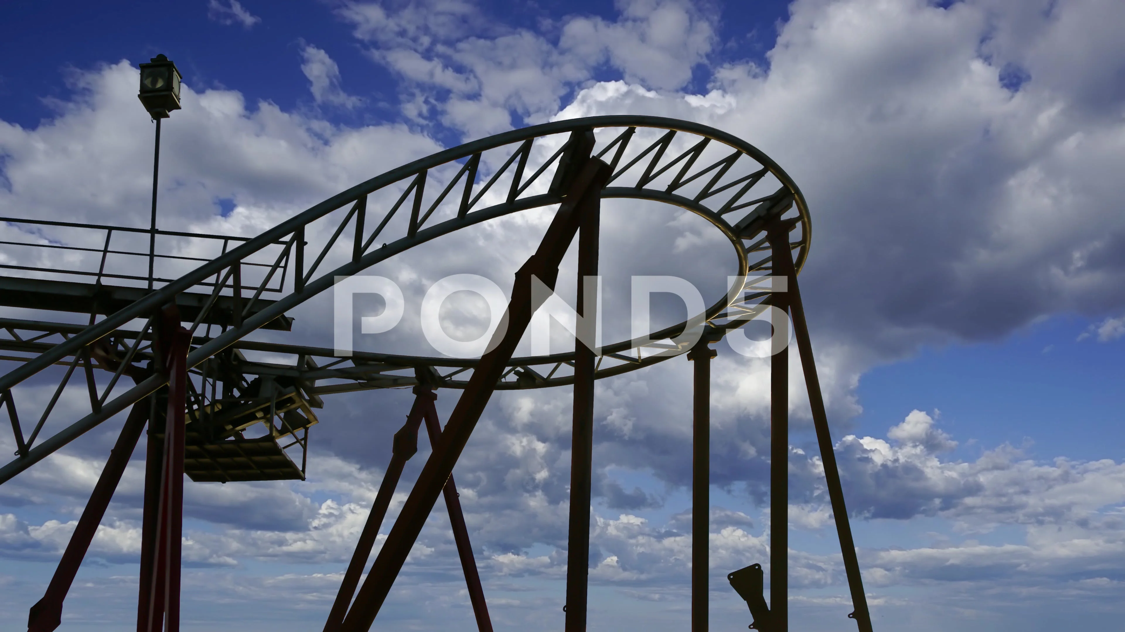 Attraction roller coaster switchback on the background of the cloudy sky