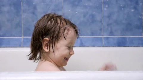 Attractive 2-3 year old girl takes a bath. Wet hair. Cute blonde child. Pretty Stock Footage 132434863
