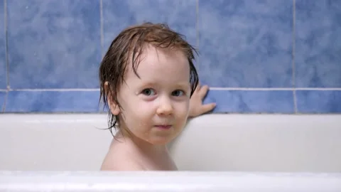 Attractive 2-3 year old girl takes a bath. Wet hair. Cute blonde child. Pretty Stock Footage 140008655
