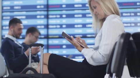 Attractive Adult Business Woman using Tablet Computer while Waiting Boarding Stock Footage